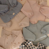 Mushie Dino ​​Long Sleeve Bib​